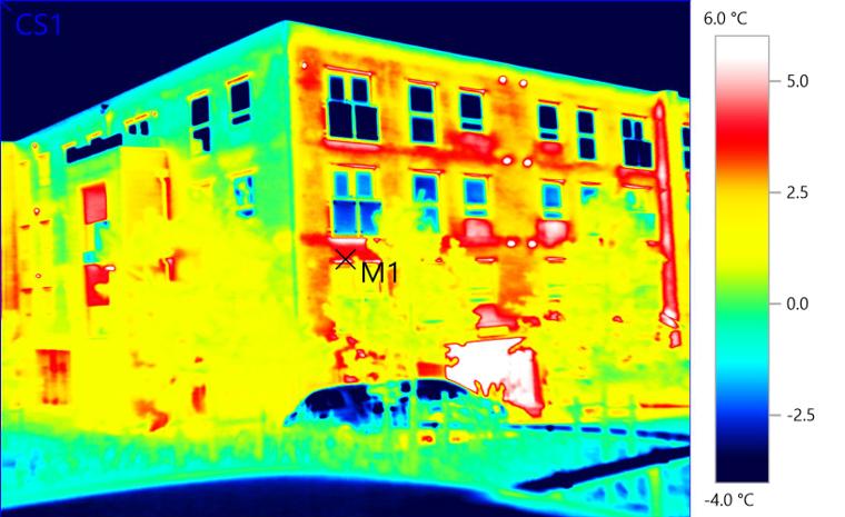 Thermal image &mdash; Residential block, fabric survey. Patchy wall temperatures revealing inconsistent cavity insulation across the elevation, informing retrofit prioritisation.
