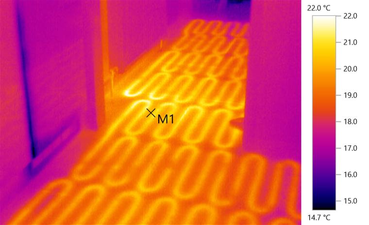 Thermal image &mdash; Underfloor heating coverage. Circuit spacing and flow verified across a hallway, with under-heated areas identified for balancing.